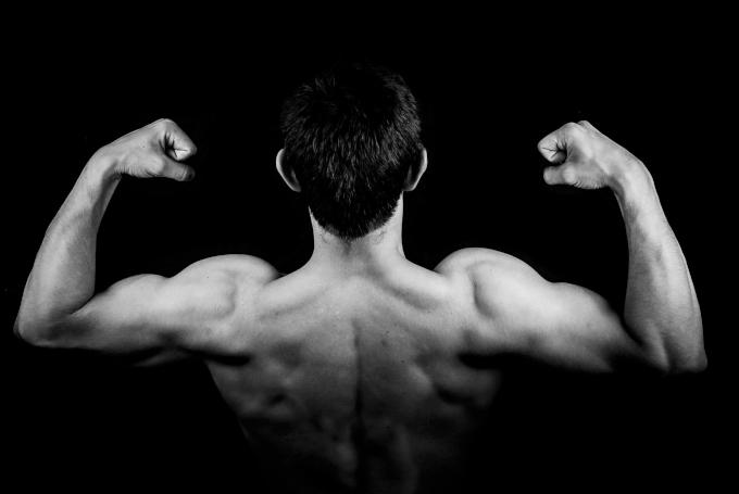 Muscular man showing his developed back