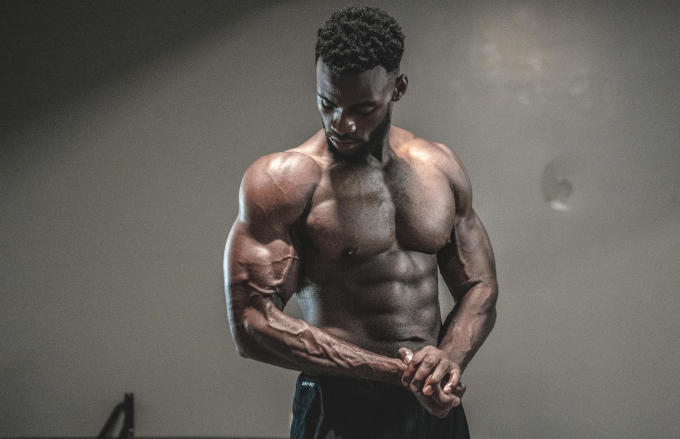 Athlete showcasing muscular development and focus through consistent training