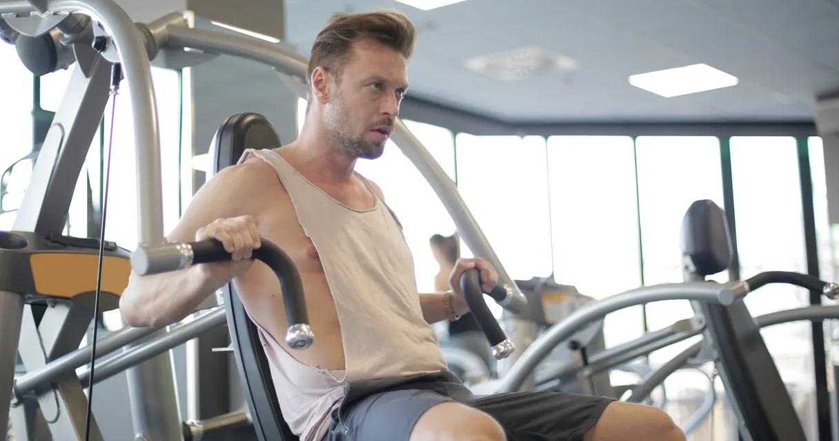 Lifter performing a controlled cable chest fly in a gym